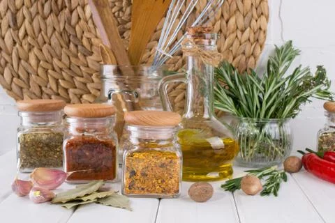 Composition of kitchen tools, spices and herbs on white table Stock Photos