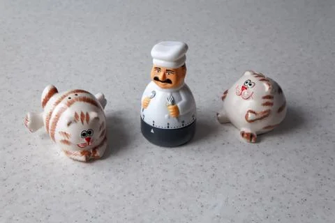 Composition of kitchen utensils in the form of a cook and fat cats Stock Photos