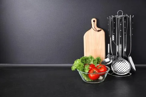 Composition with kitchenware on table against grey background. Space for text Stock Photos