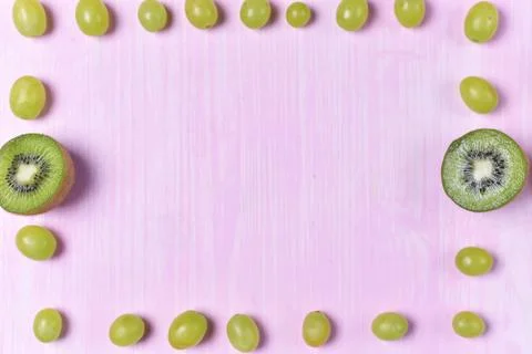 Composition of kiwi and grape Stock Photos