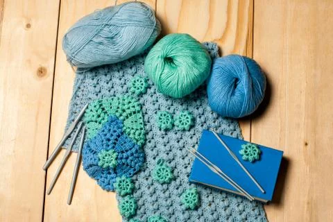 Composition of knitting tools and crocheted blue-green openwork napkins, ball Stock Photos