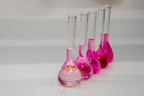 Composition of laboratory material with colored liquids in realistic glass pots Stock Photos