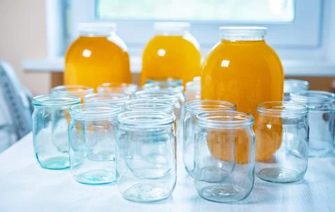 Composition of a large number of jars and three jars of honey standing on a Photos