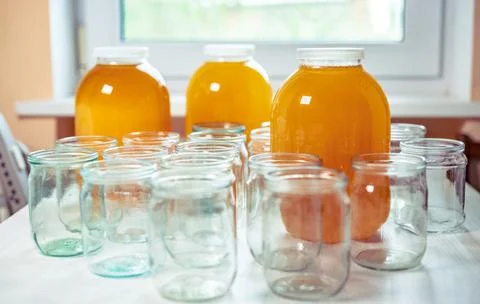 Composition of a large number of jars and three jars of honey standing on a Stock Photos