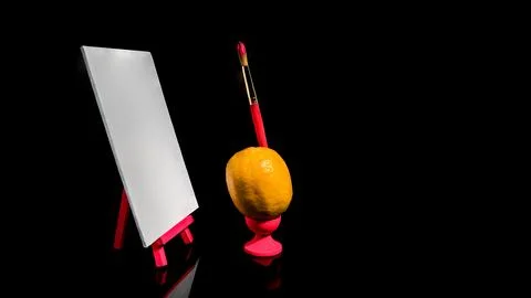 Composition with lemon and empty canvas on a black background Foto stock