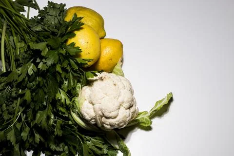 Composition of lemons and cauliflower on white background. Yellow lemons and  Stock Photos