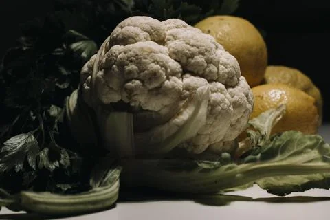 Composition of lemons and cauliflower on white background. Yellow lemons and  Foto stock