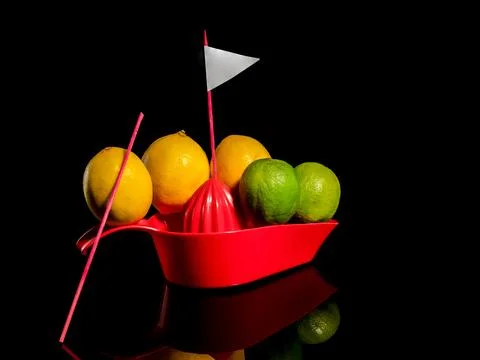 Composition with lemons and limes floating on a boat Stockfoto's