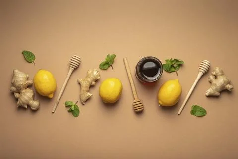 Composition with lemons, mint, ginger, honey in glass jar and honey wooden Stock Photos