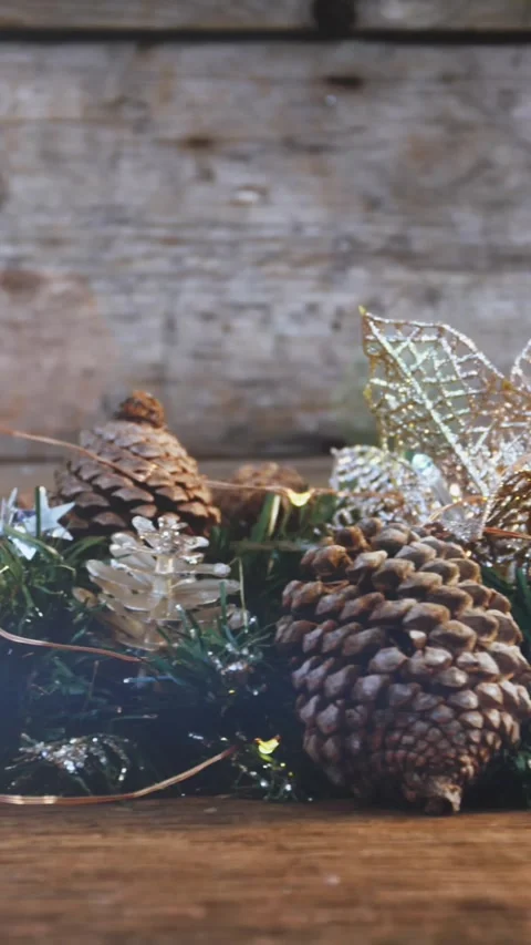 Composition of light over christmas decorations with pine cones Stock Footage 344614048