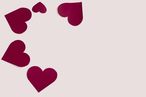 Composition of lot of different shaped red paper hearts in the corner on a white Stock Photos