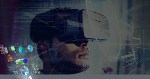 Composition of man wearing vr headset and interactive screen with data Stock Photos