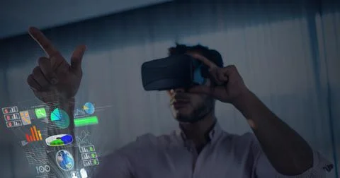 Composition of man wearing vr headset touching interactive screen with data Stock Photos