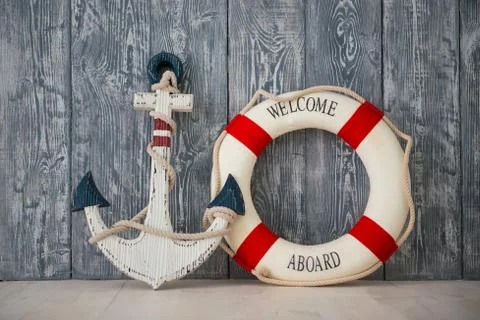 Composition on the marine theme with anchor and lifeline on wooden background Stock Photos