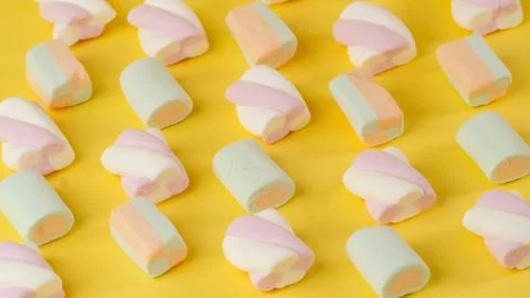 Composition of marshmallows on a yellow background - lines diagonally Stock Photos
