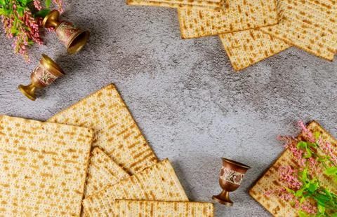 Composition with matzo bread, wine cups and flowers. Top view. Passover Jewis Stock Photos