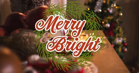 Composition of merry and bright text over christmas decorations on table Ilustração Stock