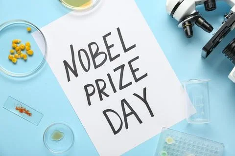 Composition with microscope, petri dishes and NOBEL PRIZE DAY greeting card o Photos