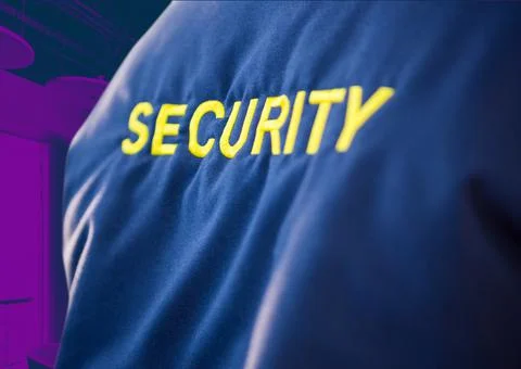 Composition of midsection of security guard blue jacket with yellow text over Stock Photos