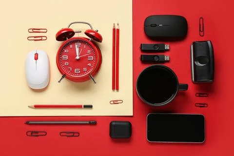 Composition with mobile phone, alarm clock, stationery and modern flash drive Stock Photos
