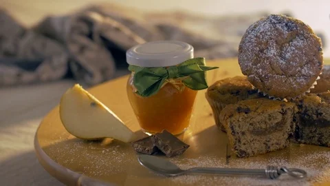 A composition of muffins, a jar of jam and a pear. Healthy homemade breakfast. Stock Footage 69714275