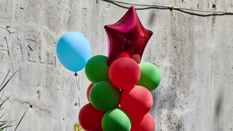 Composition from multi -colored balls. Upstairs Big red inflatable star. Stock Footage 195195188