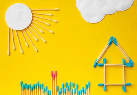 Composition of multi-colored cotton swabs buds, discs on a yellow backgroun.. Stock Photos