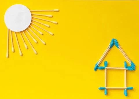 Composition of multi-colored cotton swabs buds, discs on a yellow backgroun.. Stock Photos