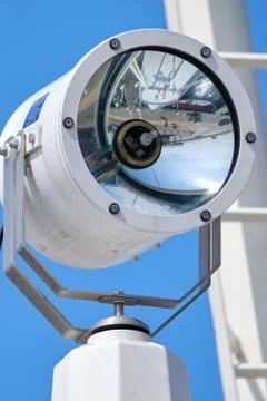 Composition is navy consisting of a lamp, and masts against a blue sky. Backg Stock Photos