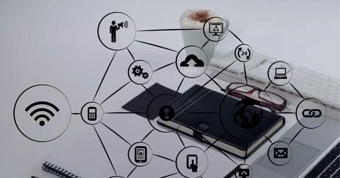 Composition of network of connections with icons over office desk Foto stock