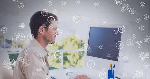 Composition of network of connections with icons over businessman using computer Stock Photos