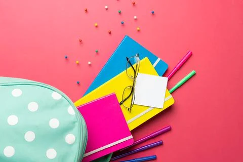 Composition of notebooks, glasses and crayons in mint dotted case on pink Stock Photos