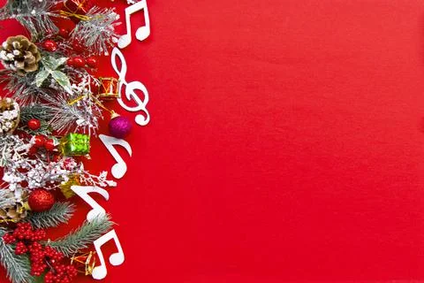 Composition with notes and christmas decorations on red background. Stock Photos