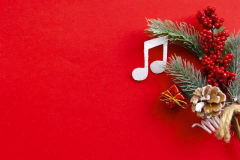 Composition with notes and christmas decorations on red background. Stock Photos