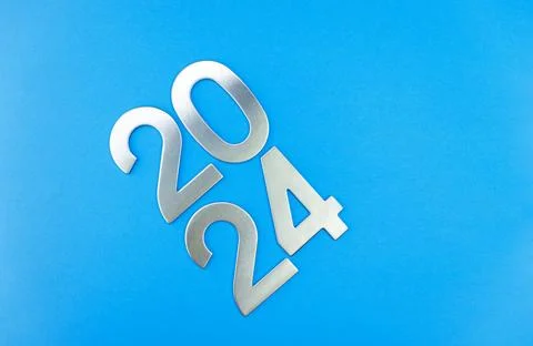 Composition with the number 2024 made of silver on a blue monochrome background Stock Photos