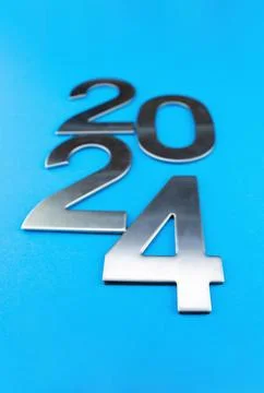 Composition with the number 2024 made of silver on a blue monochrome background Stock Photos