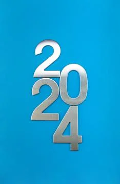 Composition with the number 2024 made of silver on a blue monochrome background Stock Photos