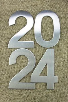 Composition with the number 2024 made of silver, metal on a jute background Stock Photos