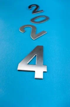 Composition with the number 2024 made of silver on a blue monochrome background Stock Photos
