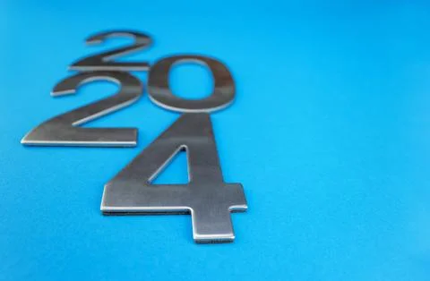 Composition with the number 2024 made of silver on a blue monochrome background Stock Photos