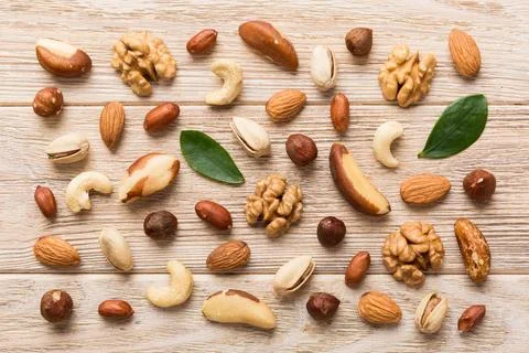 Composition of nuts , flat lay - mix hazelnuts, cashews, almonds on table bac Stock Photos