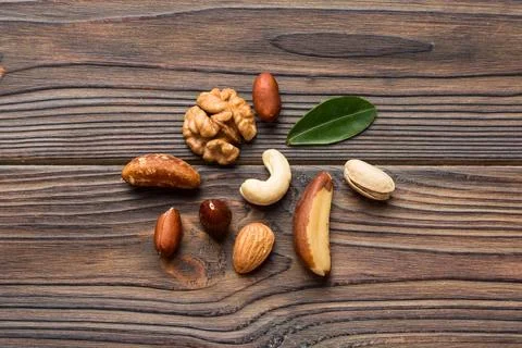 Composition of nuts , flat lay - mix hazelnuts, cashews, almonds on table bac Stock Photos