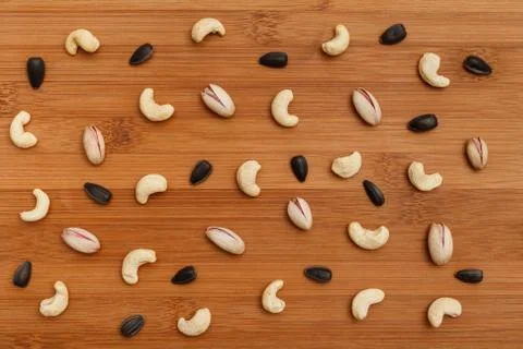 Composition of nuts pattern - mix cashews, sunflower seed, pistachios. Stock Photos