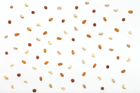 Composition of nuts pattern - mix hazelnuts, cashews, almonds, pistachios. Stock Photos