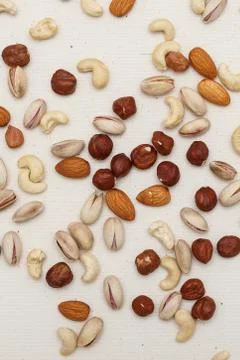 Composition of nuts pattern - mix hazelnuts, cashews, almonds, pistachios. Stock Photos