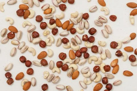 Composition of nuts pattern - mix hazelnuts, cashews, almonds, pistachios. Stock Photos