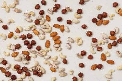 Composition of nuts pattern - mix hazelnuts, cashews, almonds, pistachios. Stock Photos