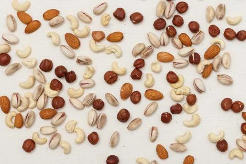 Composition of nuts pattern - mix hazelnuts, cashews, almonds, pistachios. Stock Photos