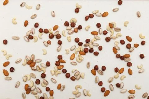 Composition of nuts pattern - mix hazelnuts, cashews, almonds, pistachios. Stock Photos