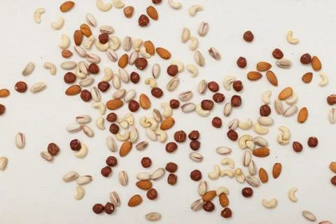 Composition of nuts pattern - mix hazelnuts, cashews, almonds, pistachios. Stock Photos